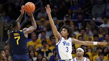 Nov 15, 2024; Pittsburgh, Pennsylvania, USA;  West Virginia Mountaineers guard Javon Small (7) shoots against Pittsburgh Panthers guard Brandin Cummings (3) during the first half at the Petersen Events Center. Mandatory Credit: Charles LeClaire-Imagn Images