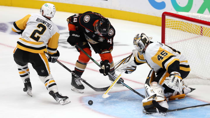 Nov 7, 2023; Anaheim, California, USA; Pittsburgh Penguins goaltender Magnus Hellberg (45) defends the goal against Anaheim Ducks left wing Ross Johnston (44) during the third period at Honda Center. Mandatory Credit: Kiyoshi Mio-USA TODAY Sports