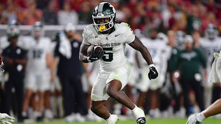 Sep 20, 2025; Los Angeles, California, USA; Michigan State Spartans running back Makhi Frazier (5) runs the ball against the Southern California Trojans during the second half at the Los Angeles Memorial Coliseum. Mandatory Credit: Gary A. Vasquez-Imagn Images