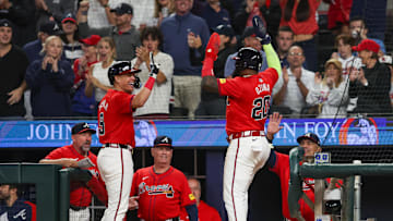 Sep 27, 2024; Atlanta, Georgia, USA; Atlanta Braves designated hitter Marcell Ozuna (20) celebrates after scoring with third baseman Gio Urshela (9) against the Kansas City Royals in the eighth inning at Truist Park. Mandatory Credit: Brett Davis-Imagn Images
