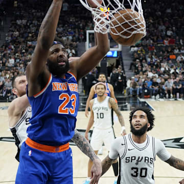 Mar 19, 2025; San Antonio, Texas, USA; New York Knicks center Mitchell Robinson (23) dunks over San Antonio Spurs guard Stephon Castle (5) and forward Julian Champagnie (30) during the second half at Frost Bank Center. Mandatory Credit: Scott Wachter-Imagn Images