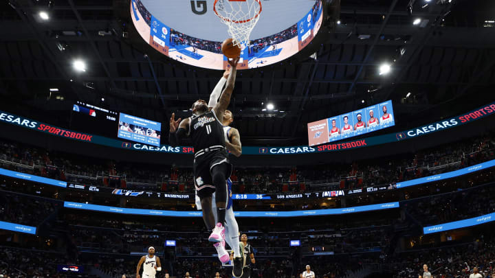 Dec 10, 2022; Washington, District of Columbia, USA; Los Angeles Clippers guard John Wall (11) goes for a dunk in the second quarter at Capital One Arena. 