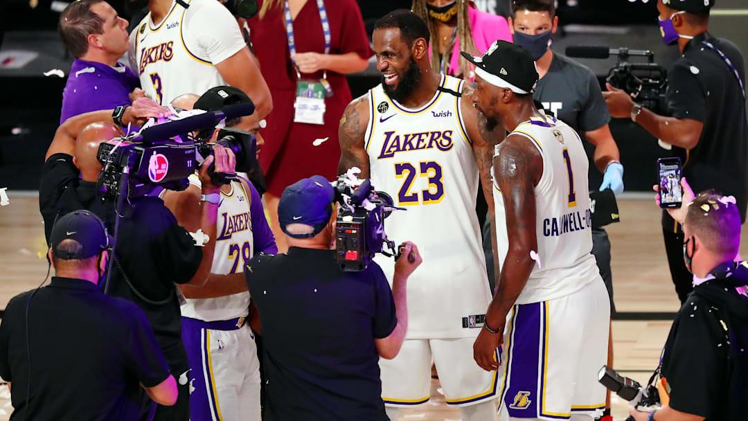 Oct 11, 2020; Lake Buena Vista, Florida, USA; Los Angeles Lakers forward LeBron James (23) celebrates with guard Kentavious Caldwell-Pope (right) after game six of the 2020 NBA Finals at AdventHealth Arena. The Los Angeles Lakers won 106-93 to win the series. Mandatory Credit: Kim Klement-Imagn Images