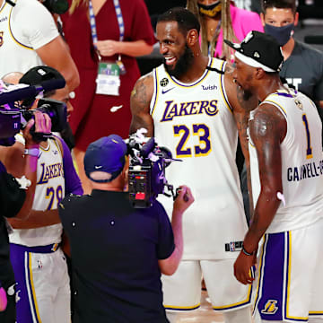 Oct 11, 2020; Lake Buena Vista, Florida, USA; Los Angeles Lakers forward LeBron James (23) celebrates with guard Kentavious Caldwell-Pope (right) after game six of the 2020 NBA Finals at AdventHealth Arena. The Los Angeles Lakers won 106-93 to win the series. Mandatory Credit: Kim Klement-Imagn Images