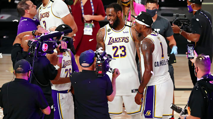 Oct 11, 2020; Lake Buena Vista, Florida, USA; Los Angeles Lakers forward LeBron James (23) celebrates with guard Kentavious Caldwell-Pope (right) after game six of the 2020 NBA Finals at AdventHealth Arena. The Los Angeles Lakers won 106-93 to win the series. Mandatory Credit: Kim Klement-Imagn Images