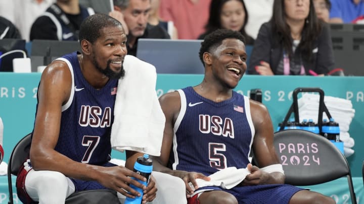 Aug 3, 2024; Villeneuve-d'Ascq, France; United States guard LeBron James (6), guard Kevin Durant (7) and guard Anthony Edwards (5) on the bench in the fourth quarter against Puerto Rico during the Paris 2024 Olympic Summer Games at Stade Pierre-Mauroy.