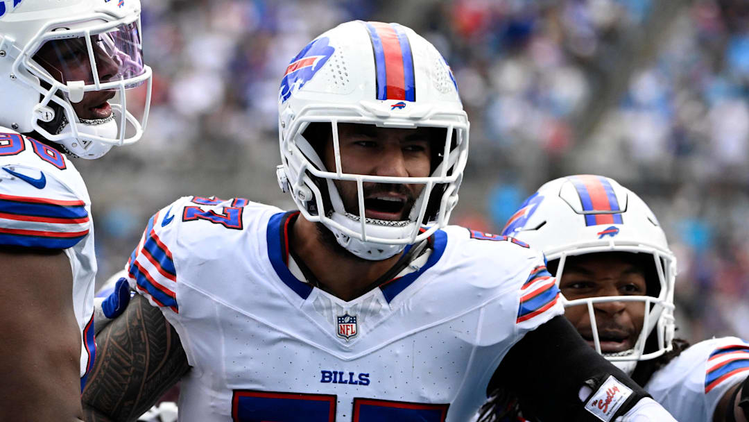 Oct 26, 2025; Charlotte, North Carolina, USA;  Buffalo Bills defensive end AJ Epenesa (57) celebrates with guard Connor McGovern (66) and linebacker Dorian Williams (42)  after intercepting a pass in the second quarter against the Carolina Panthers at Bank of America Stadium. Mandatory Credit: Bob Donnan-Imagn Images