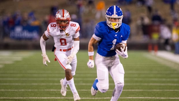 McCallie's Enrique Leclair (1) runs down the sideline on route to a touchdown during the Division II-3A championship game 