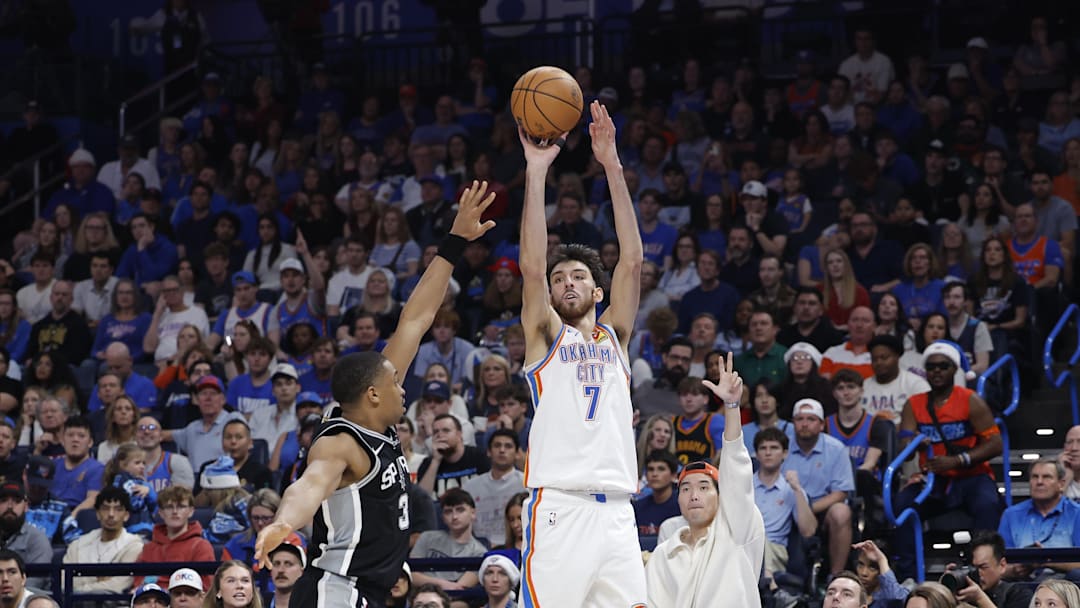 Dec 25, 2025; Oklahoma City, Oklahoma, USA; Oklahoma City Thunder center Chet Holmgren (7) shoots a three point basket as San Antonio Spurs forward Keldon Johnson (3) defends during the second half at Paycom Center. Mandatory Credit: Alonzo Adams-Imagn Images