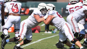 The Crimson Tide players and coaches continue working toward the season opener in practice Tuesday, Aug. 13, 2024. Alabama offensive lineman Wilkin Formby (75), left, blocks a teammate.