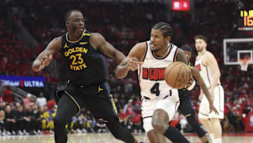 May 4, 2025; Houston, Texas, USA; Houston Rockets guard Jalen Green (4) drives with the ball as Golden State Warriors forward Draymond Green (23) defends during game seven of the first round for the 2025 NBA Playoffs at Toyota Center. Mandatory Credit: Troy Taormina-Imagn Images