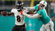 Nov 11, 2021; Miami Gardens, Florida, USA; Baltimore Ravens quarterback Lamar Jackson (8) stiff arms Miami Dolphins outside linebacker Jaelan Phillips (15) during the second half at Hard Rock Stadium. Mandatory Credit: Jasen Vinlove-Imagn Images