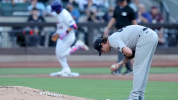 Jun 25, 2024; New York City, New York, USA; New York Yankees starting pitcher Gerrit Cole (45) reacts as New York Mets center fielder Harrison Bader (44) rounds the bases after hitting a solo home run during the second inning at Citi Field. 
