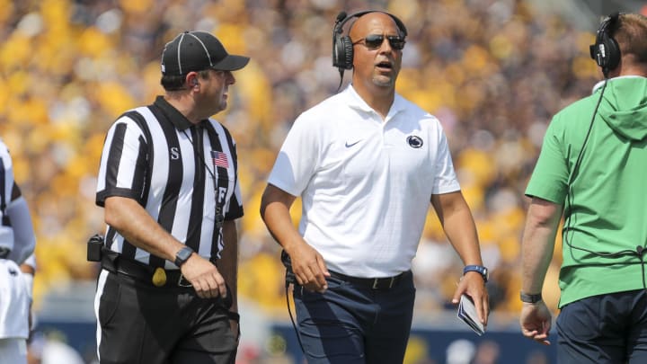 Penn State coach James Franklin talks to a referee during the first quarter against the West Virginia Mountaineers at Mountaineer Field at Milan Puskar Stadium.