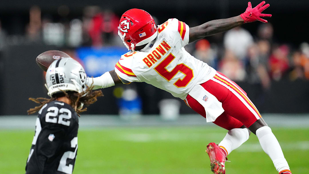 Jan 4, 2026; Paradise, Nevada, USA; Kansas City Chiefs wide receiver Hollywood Brown (5) reaches for a pass in front of Las Vegas Raiders cornerback Eric Stokes (22) during the fourth quarter at Allegiant Stadium. Mandatory Credit: Stephen R. Sylvanie-Imagn Images