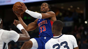 Oct 6, 2025; Memphis, Tennessee, USA; Detroit Pistons guard Jaden Ivey (23) drives to the basket as Memphis Grizzlies forward Cedric Coward (23) defends during the second quarter at FedExForum. Mandatory Credit: Petre Thomas-Imagn Images