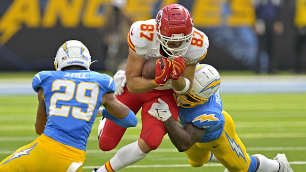 Kansas City Chiefs tight end Travis Kelce (87) is stopped by a pair of Los Angeles Chargers defenders.