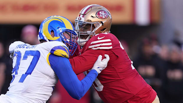 San Francisco 49ers guard Jaylon Moore (right) blocks Los Angeles Rams linebacker Michael Hoecht (97) during a game.