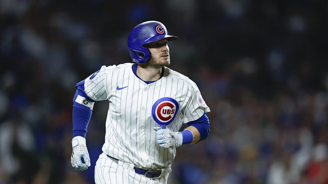 Sep 17, 2024; Chicago, Illinois, USA; Chicago Cubs outfielder Ian Happ (8) rounds the bases after hitting a solo home run against the Oakland Athletics during the third inning at Wrigley Field. 
