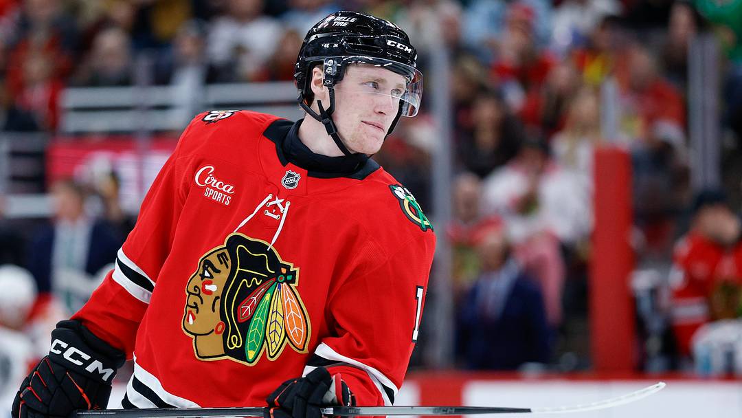 Nov 18, 2025; Chicago, Illinois, USA; Chicago Blackhawks center Oliver Moore (11) looks on during the second period of an NHL game against the Calgary Flames at United Center. Mandatory Credit: Kamil Krzaczynski-Imagn Images