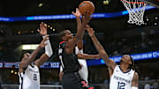 Nov 5, 2025; Memphis, Tennessee, USA; Houston Rockets forward Kevin Durant (7) shoots as Memphis Grizzlies forward/center Jaren Jackson Jr. (8), forward Cedric Coward (23) and guard Ja Morant (12) defend during the fourth quarter at FedExForum. Mandatory Credit: Petre Thomas-Imagn Images