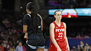 Indiana Fever guard Caitlin Clark walks by Chicago Sky forward Angel Reese.