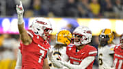 UNLV Rebels linebacker Jackson Woodard (7) and defensive back Cameron Oliver (5) celebrate after a play in the first half against the California Golden Bears at SoFi Stadium.