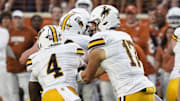 Sep 16, 2023; Austin, Texas, USA; Wyoming Cowboys quarterback Evan Svoboda (17) hands off to running back Harrison Waylee (4) before running for a touchdown in the first half against the Texas Longhorns at Darrell K Royal-Texas Memorial Stadium. Mandatory Credit: Scott Wachter-Imagn Images