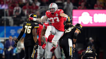Dec 29, 2023; Arlington, Texas, USA; Ohio State Buckeyes defensive end Jack Sawyer (33) celebrates a sack of Missouri Tigers quarterback Brady Cook (12) in the second quarter during the Goodyear Cotton Bowl Classic at AT&T Stadium.