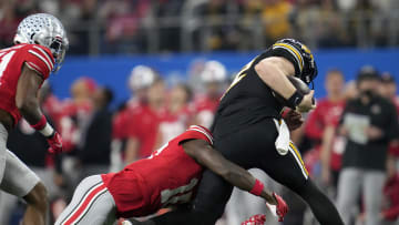 Dec 29, 2023; Arlington, TX, USA; Ohio State Buckeyes cornerback Denzel Burke (10) tackles Missouri Tigers quarterback Brady Cook (12) on a run in the first quarter during the Goodyear Cotton Bowl Classic at AT&T Stadium. Mandatory Credit: Kyle Robertson-USA TODAY Sports