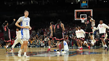 Apr 5, 2025; San Antonio, TX, USA; Duke Blue Devils forward Cooper Flagg (2) walks off the court as Houston Cougars players celebrate after Houston’s semifinal win in the men's 2025 NCAA tournament at Alamodome. Mandatory Credit: Bob Donnan-Imagn Images