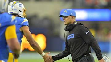 Dec 19, 2024; Inglewood, California, USA;  Los Angeles Chargers head coach Jim Harbaugh congratulates quarterback Justin Herbert (10) after a touchdown in the second half against the Denver Broncos at SoFi Stadium. Mandatory Credit: Jayne Kamin-Oncea-Imagn Images
