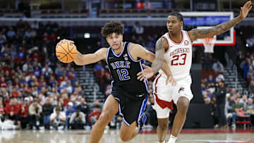 Nov 27, 2025; Chicago, Illinois, USA; Duke Blue Devils forward Cameron Boozer (12) drives to the basket against Arkansas Razorbacks forward Nick Pringle (23) during the second half at United Center. Mandatory Credit: Kamil Krzaczynski-Imagn Images