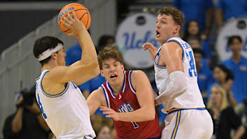 Nov 10, 2025; Los Angeles, California, USA;  UCLA Bruins forward Tyler Bilodeau (34) looks for a pass from UCLA Bruins guard Jamar Brown (4) as West Georgia Wolves guard Brady Hardewig (1) defends during the first half at Pauley Pavilion presented by Wescom Financial. Mandatory Credit: Jayne Kamin-Oncea-Imagn Images