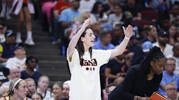 Jul 27, 2025; Chicago, Illinois, USA; Injured Indiana Fever guard Caitlin Clark (22) reacts during the first half of a basketball game against the Chicago Sky at United Center. Mandatory Credit: Kamil Krzaczynski-Imagn Images