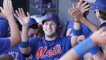 Mar 26, 2022; Port St. Lucie, Florida, USA;  New York Mets catcher Hayden Senger gets high fives from teammates after scoring a run  during the fifth inning against the Washington Nationals at Clover Park. Mandatory Credit: Reinhold Matay-Imagn Images