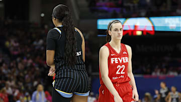 Indiana Fever guard Caitlin Clark walks by Chicago Sky forward Angel Reese.