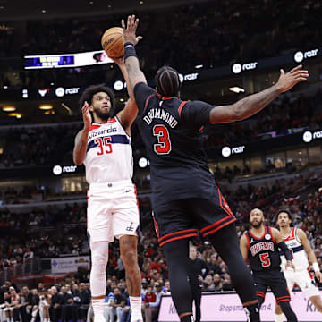 Mar 25, 2024; Chicago, Illinois, USA; Washington Wizards forward Marvin Bagley III (35) shoots against Chicago Bulls center Andre Drummond (3) during the second half at United Center. Mandatory Credit: Kamil Krzaczynski-Imagn Images