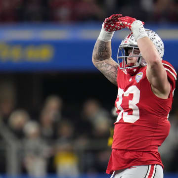 Dec 29, 2023; Arlington, TX, USA;  Ohio State Buckeyes defensive end Jack Sawyer (33) celebrates his sack of Missouri Tigers quarterback Brady Cook (12) in the third quarter during the Goodyear Cotton Bowl Classic at AT&T Stadium. Mandatory Credit: Kyle Robertson-USA TODAY Sports