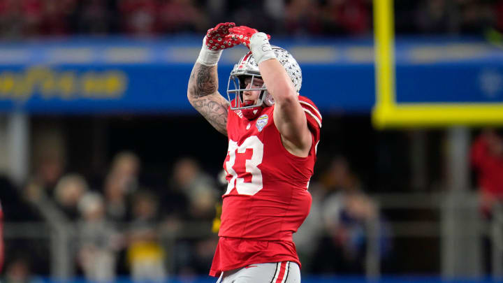 Dec 29, 2023; Arlington, Texas, USA; Ohio State Buckeyes defensive end Jack Sawyer (33) celebrates his sack of Missouri Tigers quarterback Brady Cook (12) in the third quarter during the Goodyear Cotton Bowl Classic at AT&T Stadium.