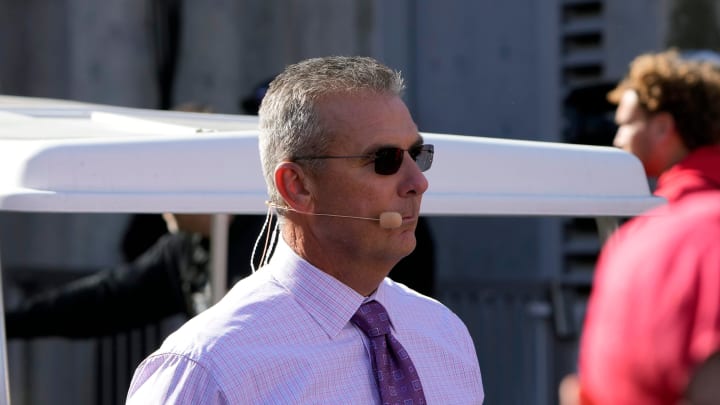 Oct 21, 2023; Columbus, Ohio, USA; Former Ohio State Buckeye football coach Urban Meyer walks to the Big Noon Kickoff show set before the Penn State Nittany Lions game at Ohio Stadium.