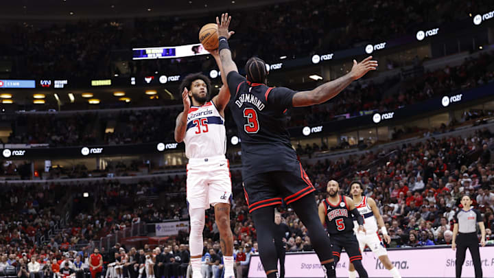 Mar 25, 2024; Chicago, Illinois, USA; Washington Wizards forward Marvin Bagley III (35) shoots against Chicago Bulls center Andre Drummond (3) during the second half at United Center. Mandatory Credit: Kamil Krzaczynski-Imagn Images