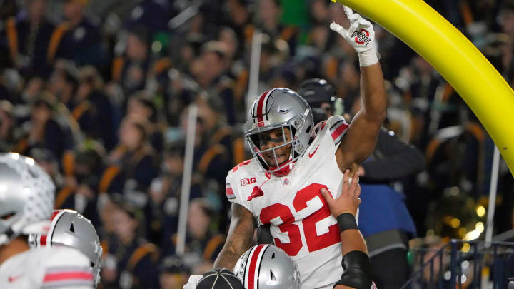 Sep 23, 2023; South Bend, Indiana, USA; Ohio State Buckeyes running back TreVeyon Henderson (32) celebrates his rushing touchdown with Ohio State Buckeyes offensive lineman Carson Hinzman (75) during the third quarter of their game against Notre Dame Fighting Irish at Notre Dame Stadium.