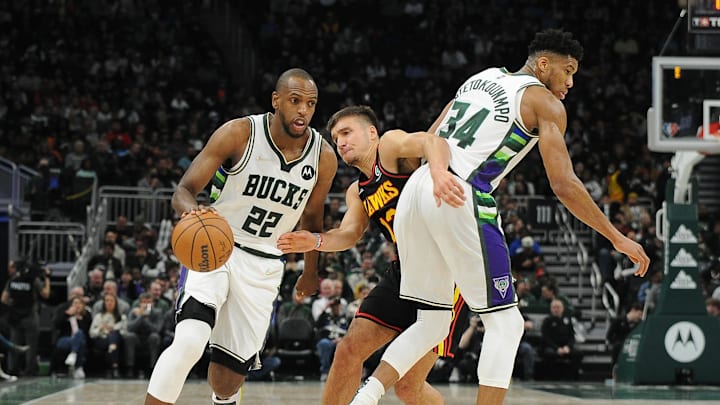 Mar 9, 2022; Milwaukee, Wisconsin, USA; Milwaukee Bucks forward Khris Middleton (22) drives past the pick of Milwaukee Bucks forward Giannis Antetokounmpo (34) as Atlanta Hawks guard Bogdan Bogdanovic (13) attempts to work his way through the pick in the first quarter at Fiserv Forum. Mandatory Credit: Michael McLoone-Imagn Images