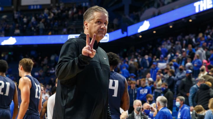 Former Kentucky Wildcats head coach John Calipari waves to the crowd.