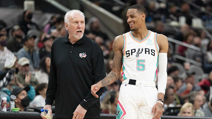San Antonio Spurs head coach Gregg Popovich shares a laugh with guard Dejounte Murray. San Antonio Spurs head coach Gregg Popovich shares a laugh with guard Dejounte Murray.