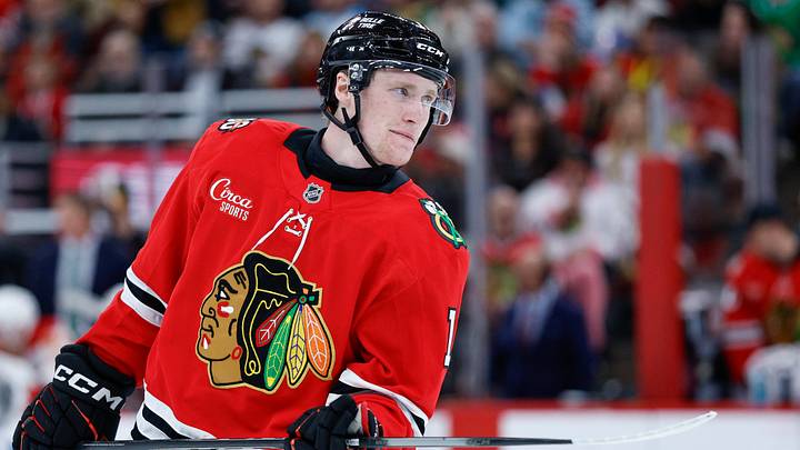Nov 18, 2025; Chicago, Illinois, USA; Chicago Blackhawks center Oliver Moore (11) looks on during the second period of an NHL game against the Calgary Flames at United Center. Mandatory Credit: Kamil Krzaczynski-Imagn Images