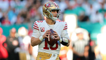 Dec 22, 2024; Miami Gardens, Florida, USA; San Francisco 49ers quarterback Brock Purdy (13) looks for a passing option against the Miami Dolphins during the first quarter at Hard Rock Stadium.