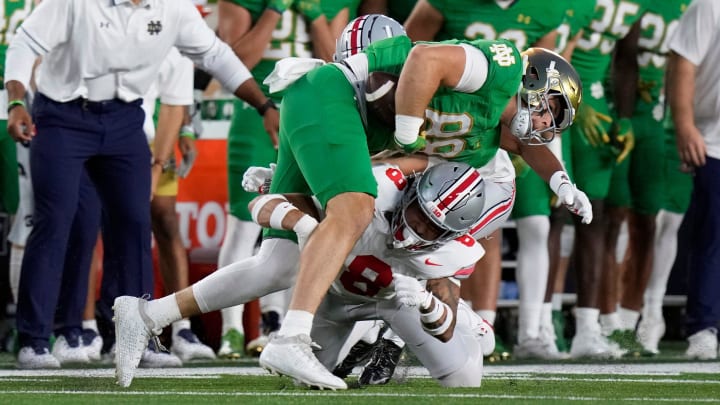 Sep 23, 2023; South Bend, Indiana, USA; Ohio State Buckeyes safety Lathan Ransom (8) tackles Notre Dame Fighting Irish tight end Mitchell Evans (88) after a catch during the first quarter of their game at Notre Dame Stadium.