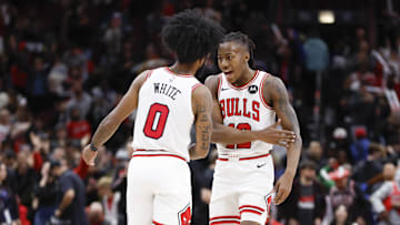 Dec 2, 2023; Chicago, Illinois, USA; Chicago Bulls guard Coby White (0) celebrates with guard Ayo Dosunmu (12) after defeating the New Orleans Pelicans at United Center. Mandatory Credit: Kamil Krzaczynski-Imagn Images